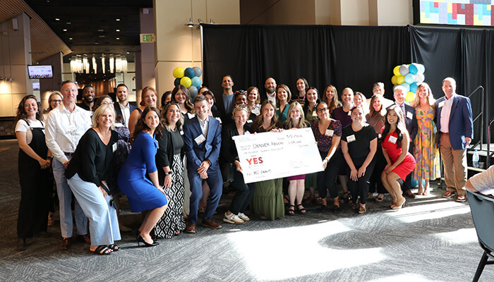Denver Region recipients holding the Yes Grants award check