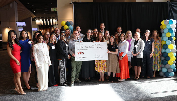 Pikes Peak award recipients holding the award check